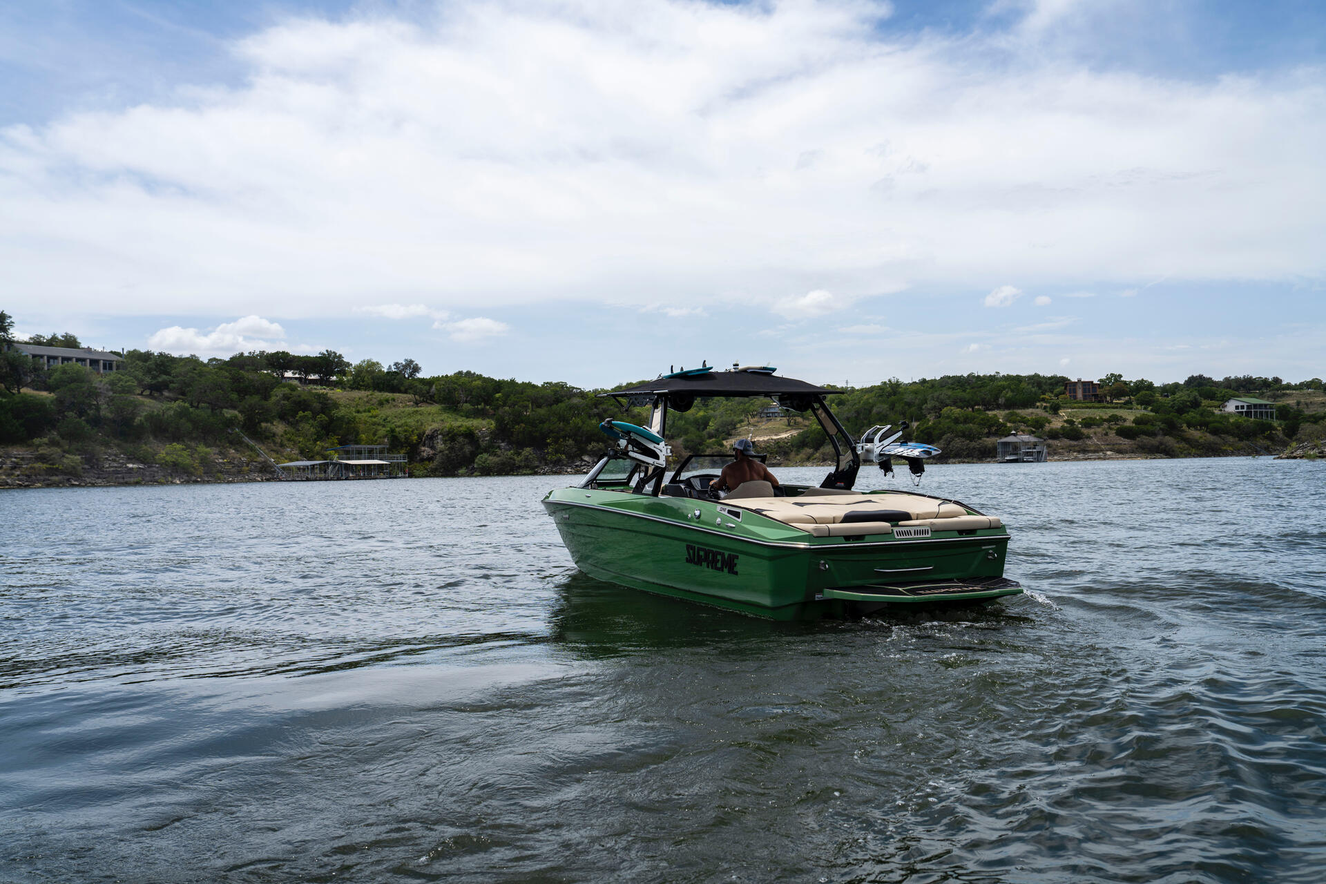 Supreme wake boat from distance on Lake Travis