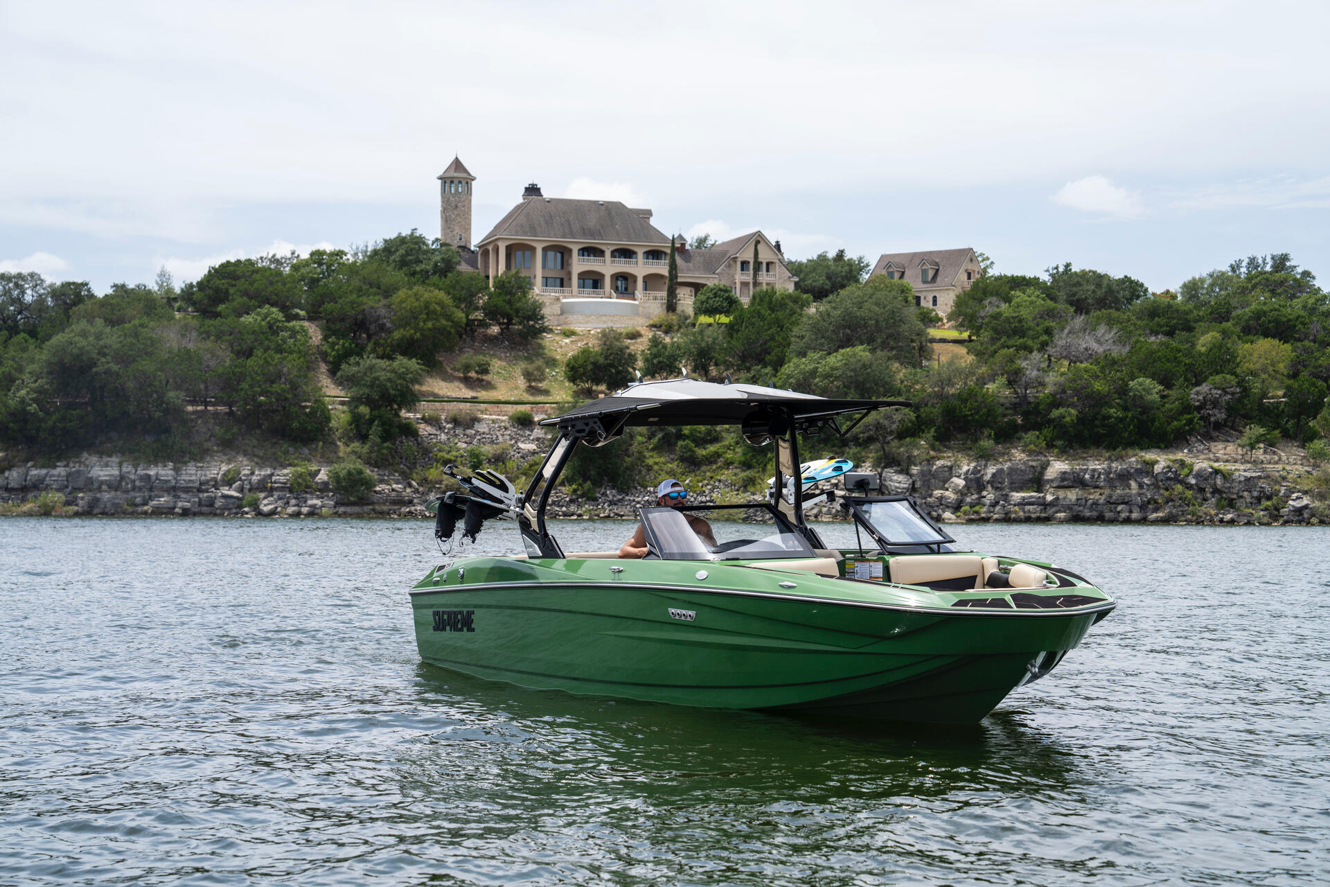 Supreme S240 wake boat with scenic Lake Travis background